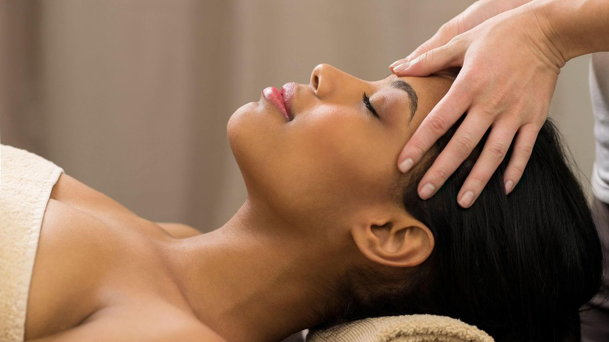 Client relaxing during a seated head and neck massage session